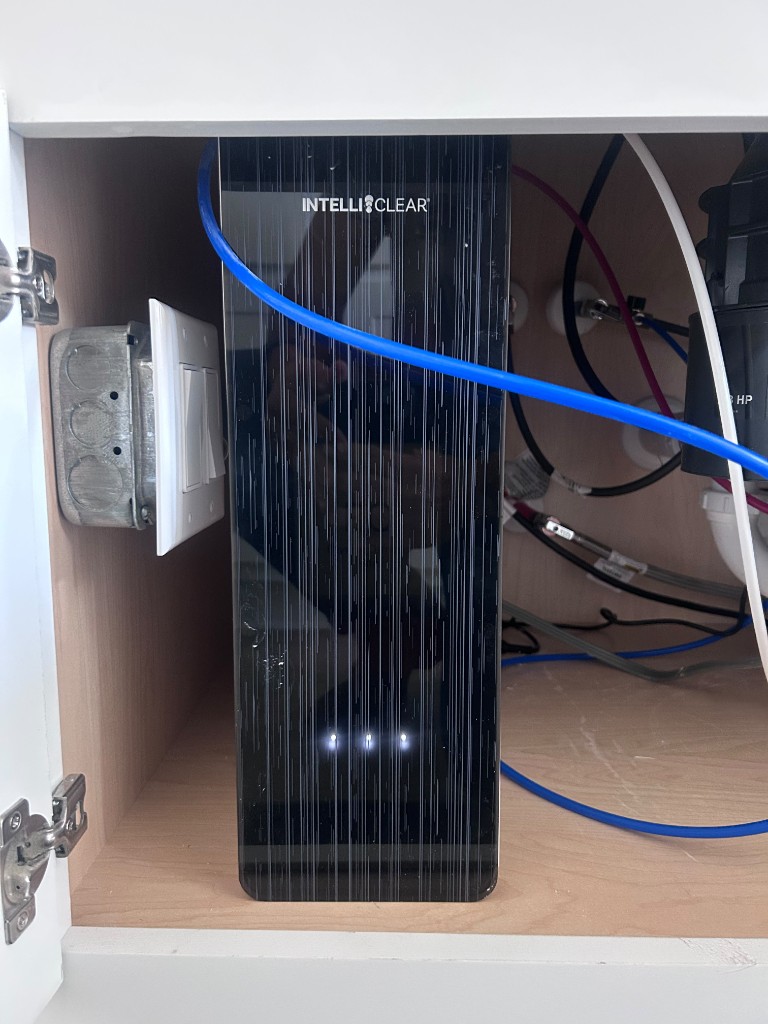 IntelliClear tankless reverse osmosis system installed under a kitchen sink