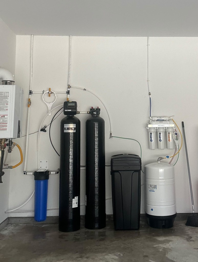 Water softener, catalytic carbon tank, pre-filter and reverse osmosis system installed in a Houston garage